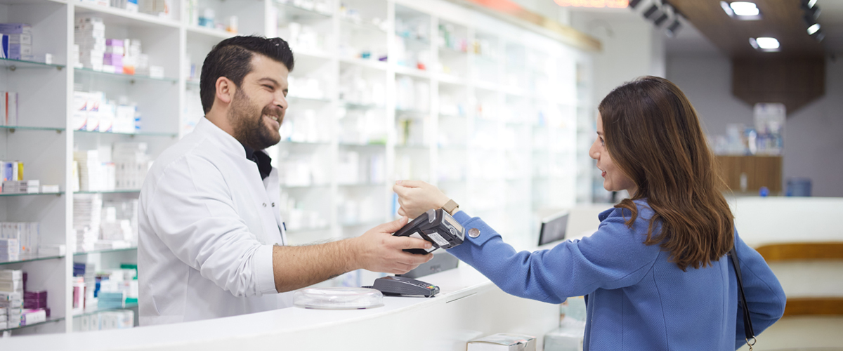 Woman at paying at pharmacy counter